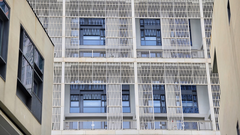 a tall white building with lots of windows