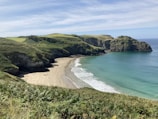 Coastal terrain showcasing sandy beach frontage with calm blue waters.