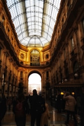 a group of people walking through a large building