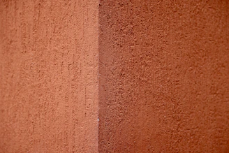 a close up of a red wall with a white stripe