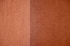 a close up of a red wall with a white stripe