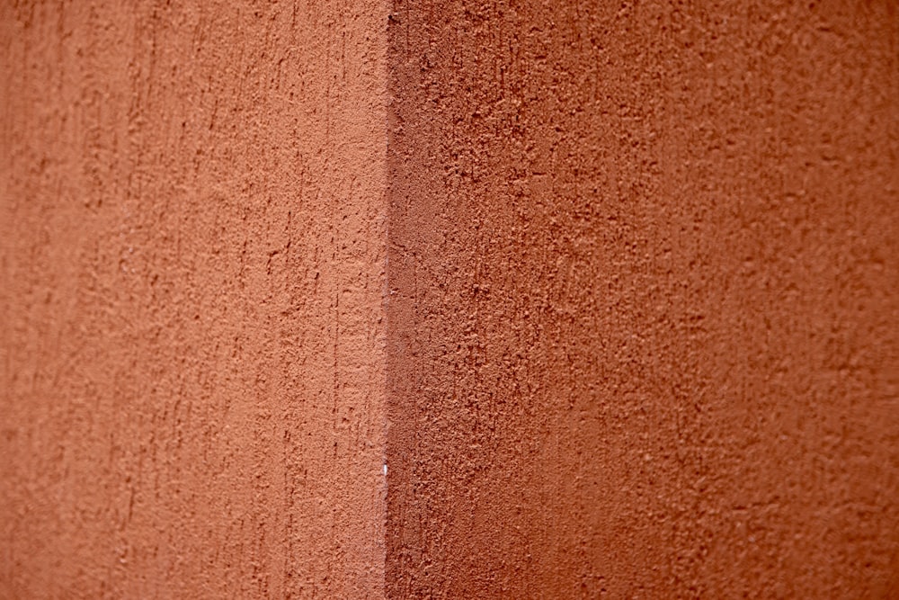 a close up of a red wall with a white stripe
