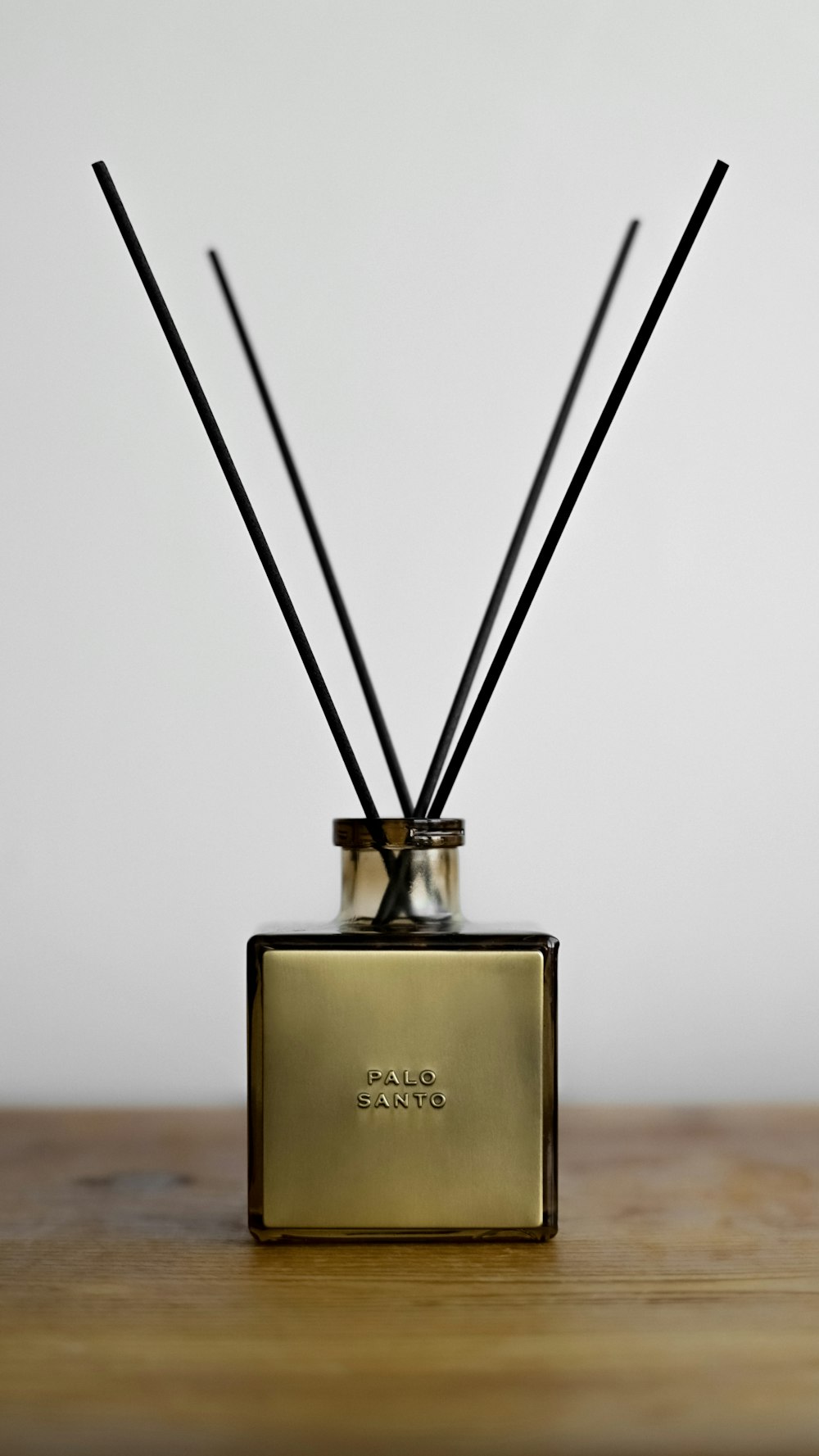 a glass container with two sticks sticking out of it