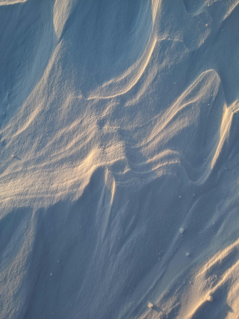 a snowboarder riding down a snow covered slope