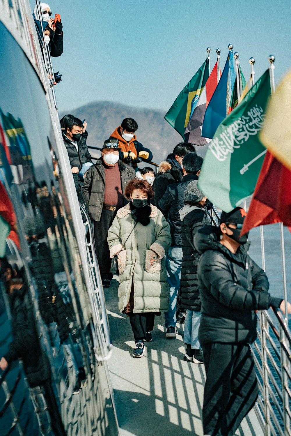 a group of people walking across a bridge