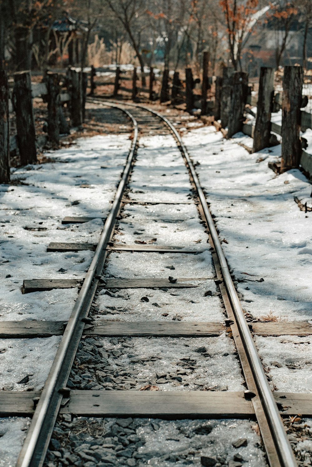 a train track in the middle of a snowy area