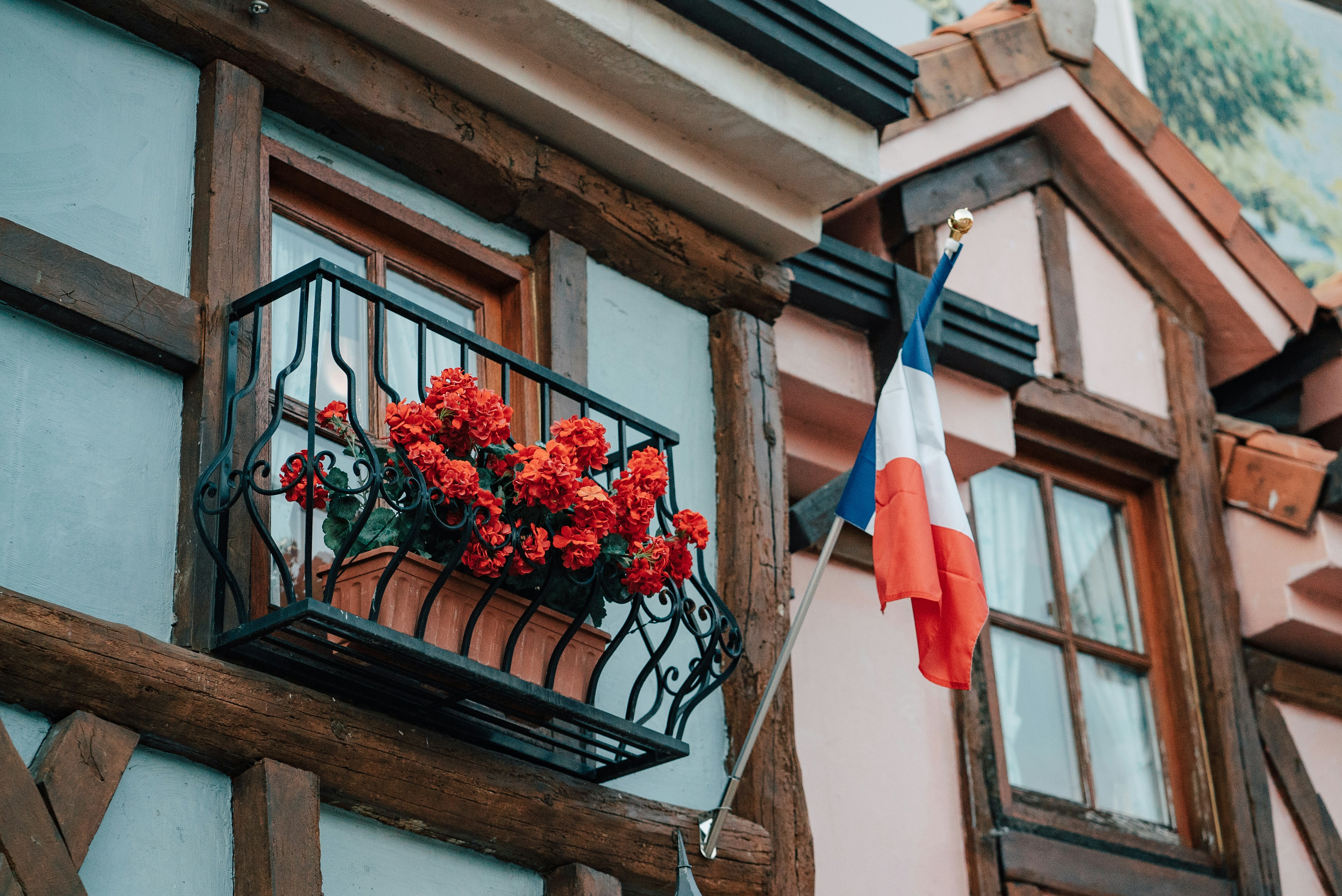 a balcony with a basket of flowers on it