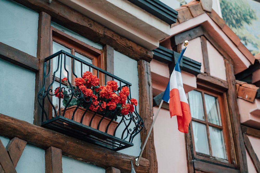 a balcony with a basket of flowers on it