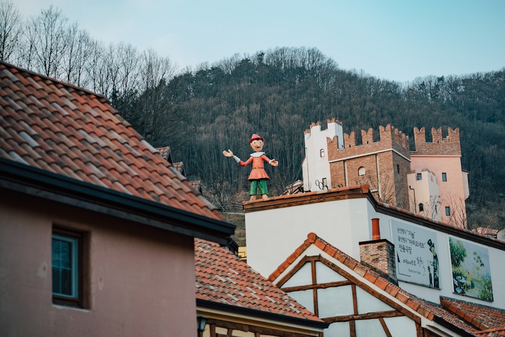 a statue of a girl on top of a building