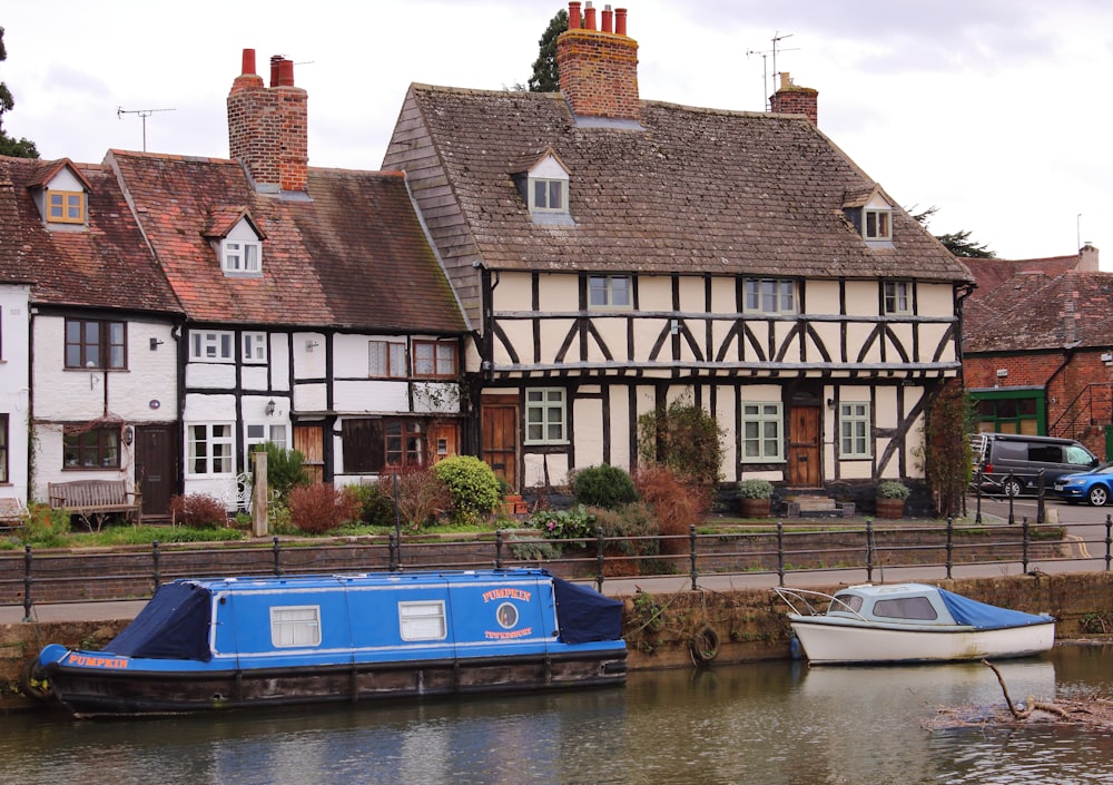 a house with a boat in the water in front of it