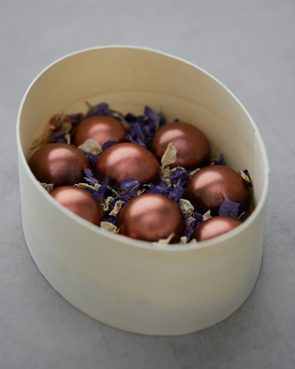 a white bowl filled with lots of ornaments