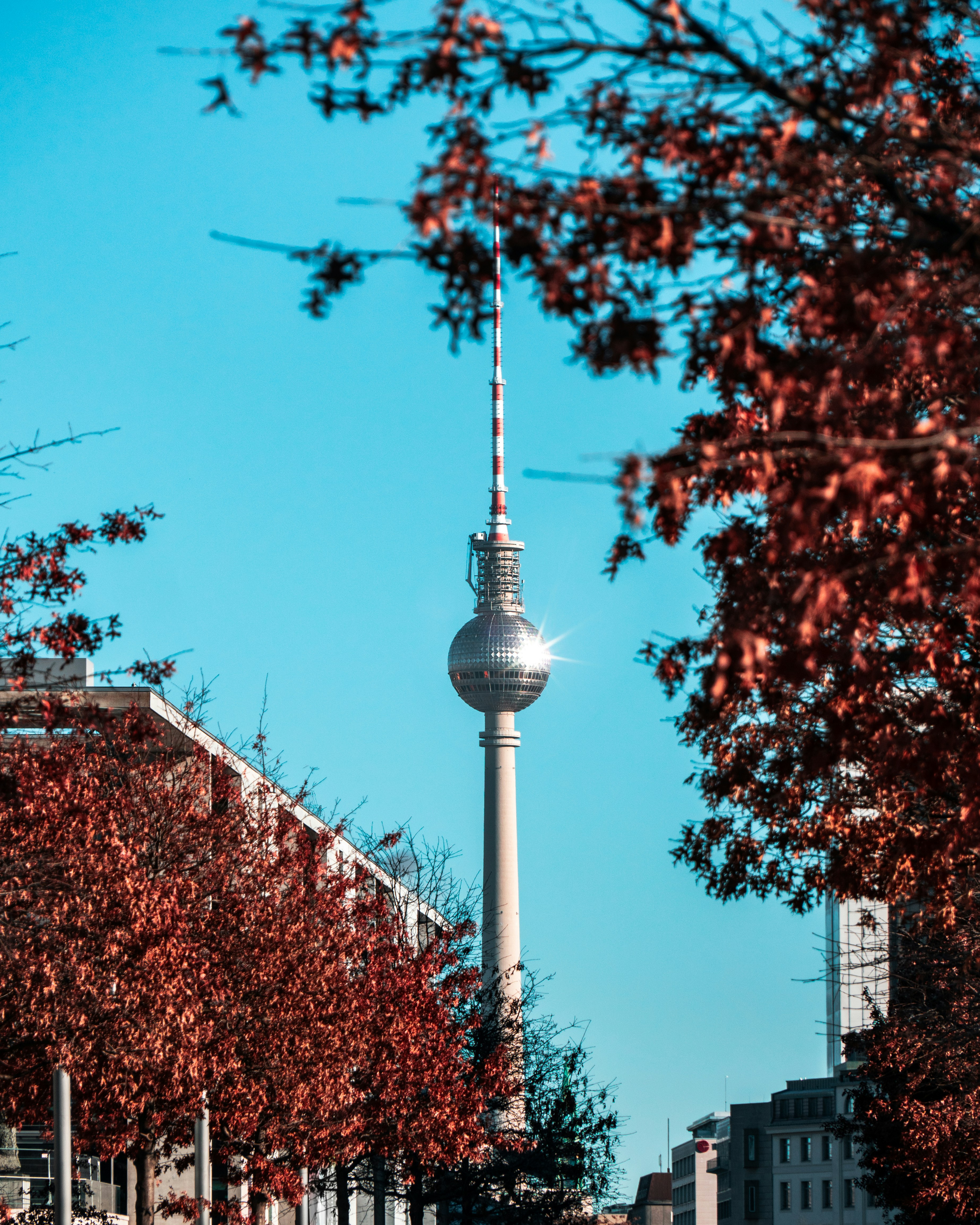 a view of a tall tower with a sky scraper in the background