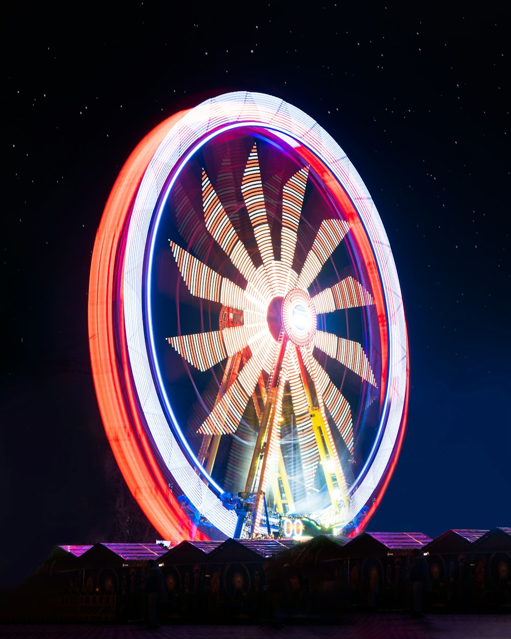 a ferris wheel lit up in the night sky