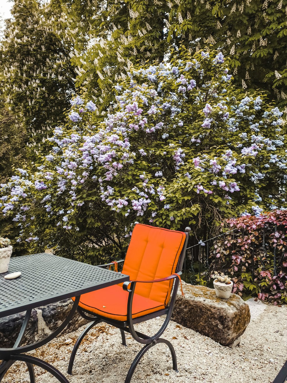 an orange chair sitting on top of a black table