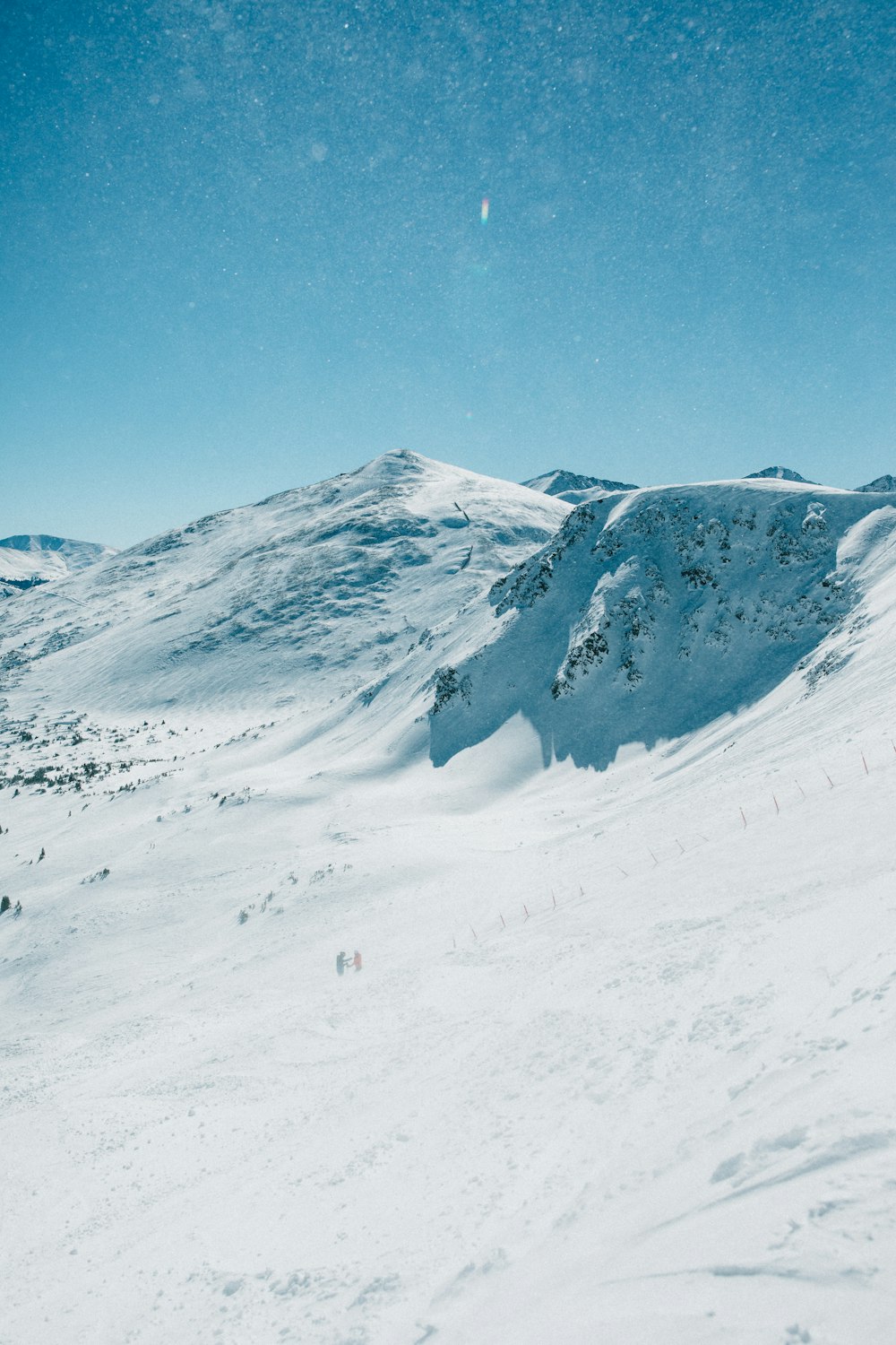 a man riding skis down a snow covered slope