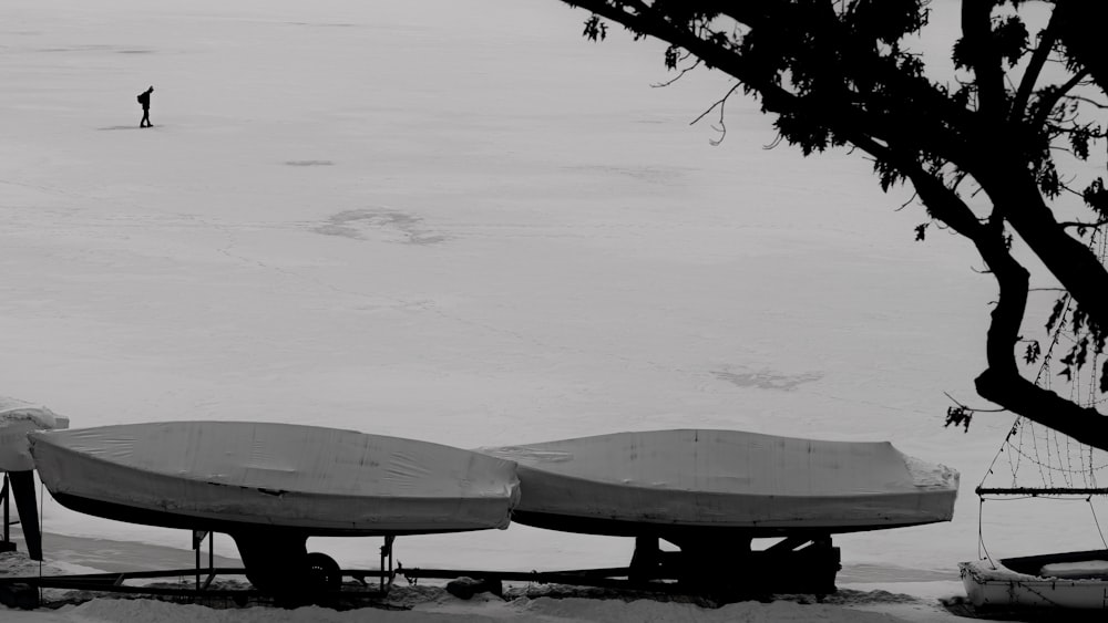 a couple of boats that are sitting in the snow