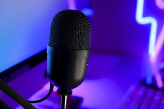 a microphone sitting in front of a laptop computer