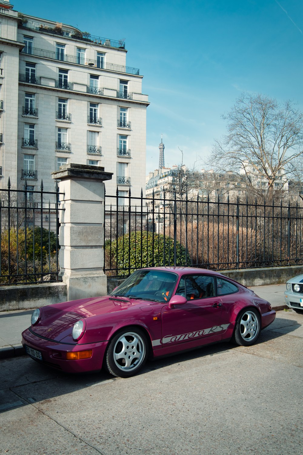 a red sports car parked on the side of the road