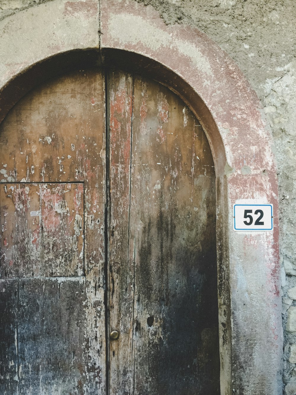 an old door with a number 52 on it