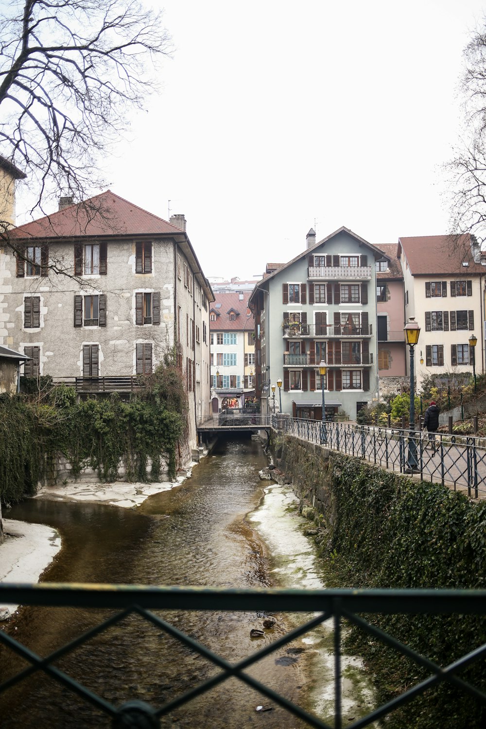 a river running through a city next to tall buildings