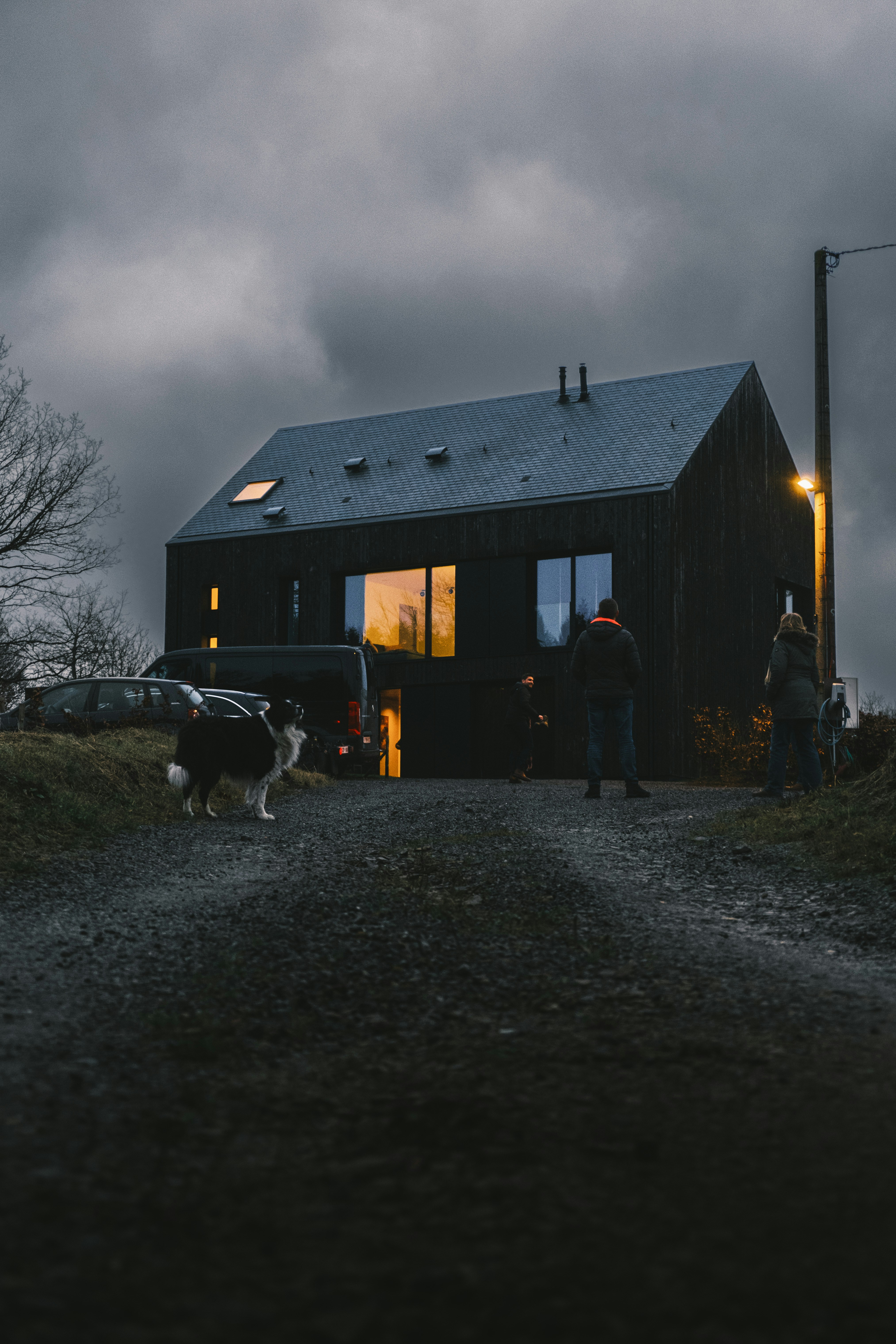 a couple of people standing outside of a house