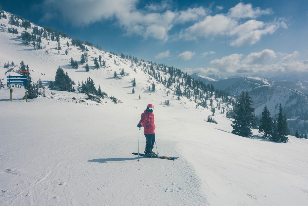 a person on skis on a snowy slope