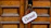 Close-up of a wooden door with a handmade open/closed sign hanging neatly.