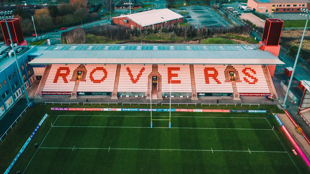 an aerial view of a soccer field with a building in the background