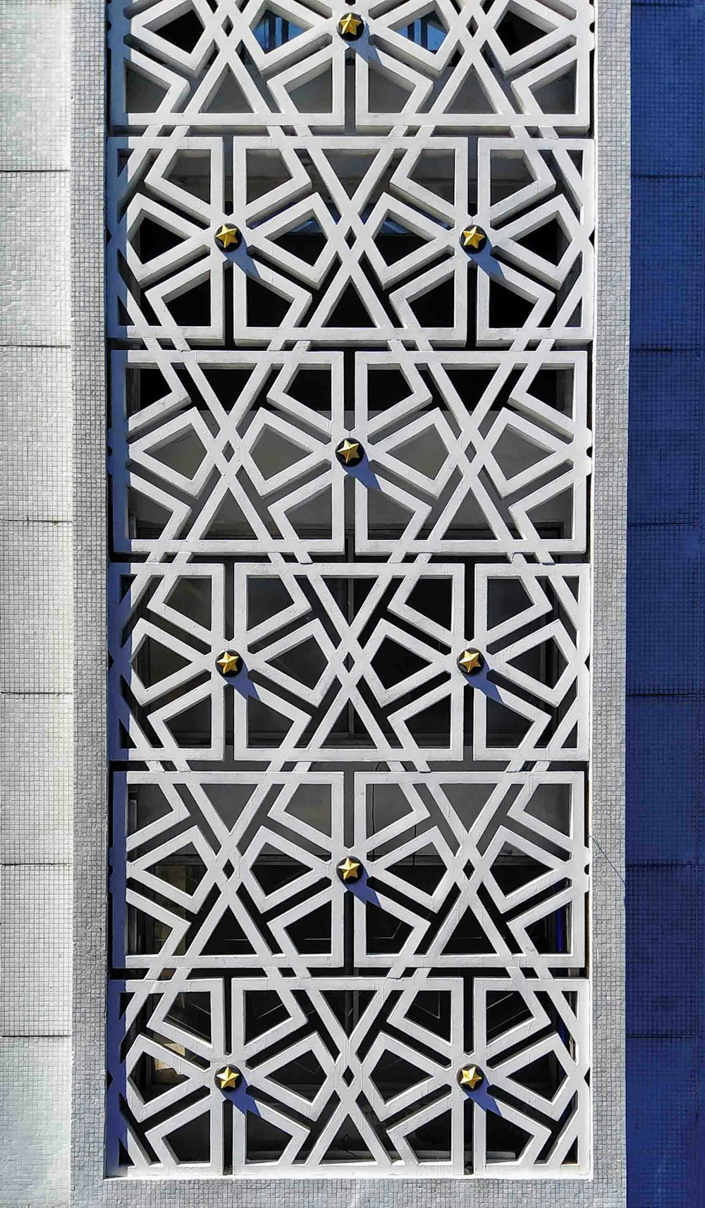 a close up of a metal structure with a blue background