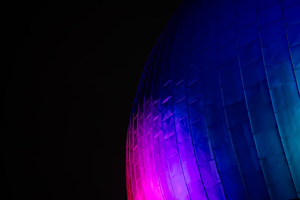 a close up of a building with a colorful light on it