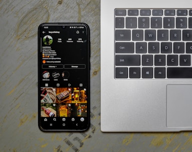 a cell phone sitting next to a laptop computer