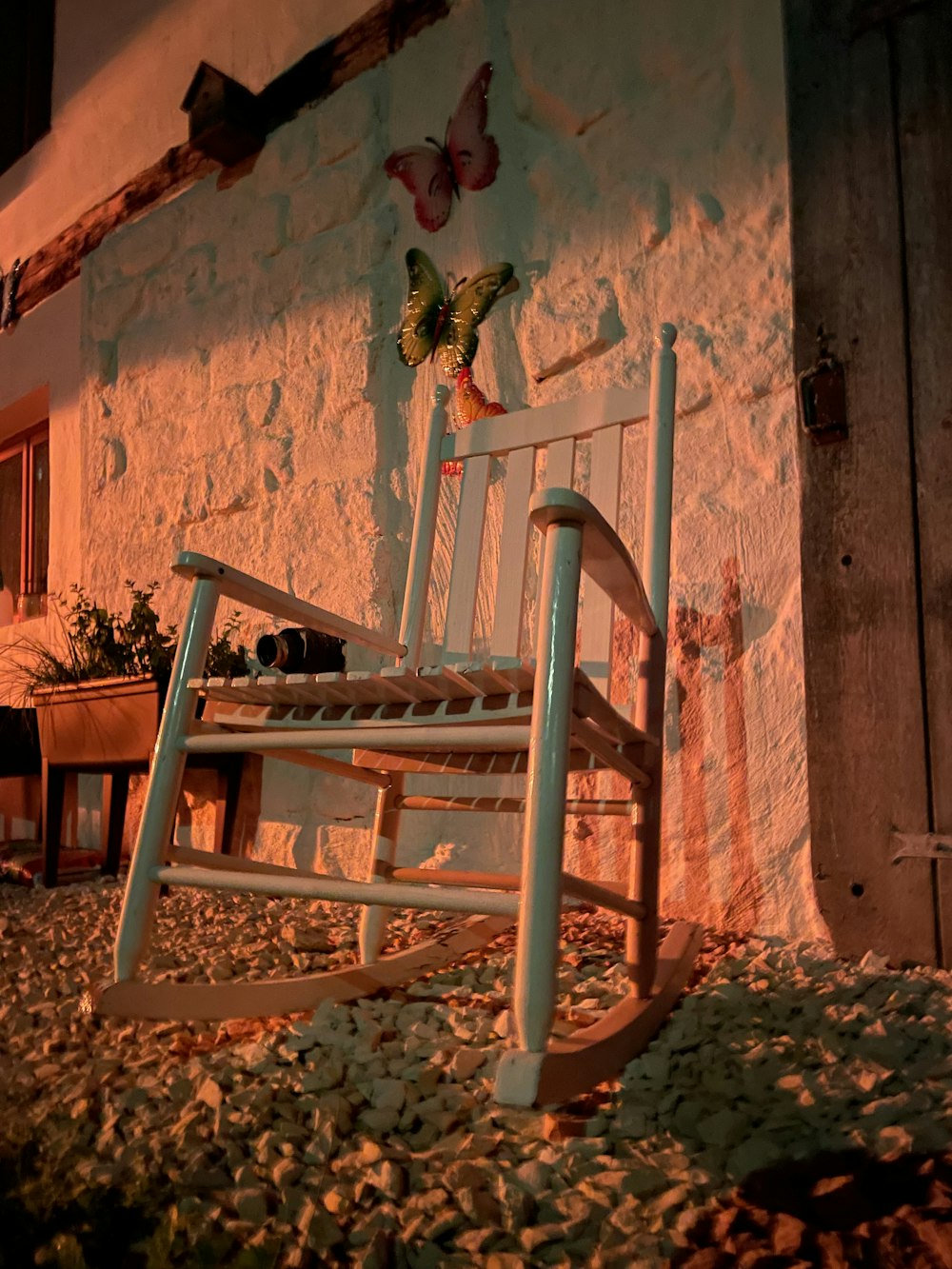 a white rocking chair sitting in front of a building