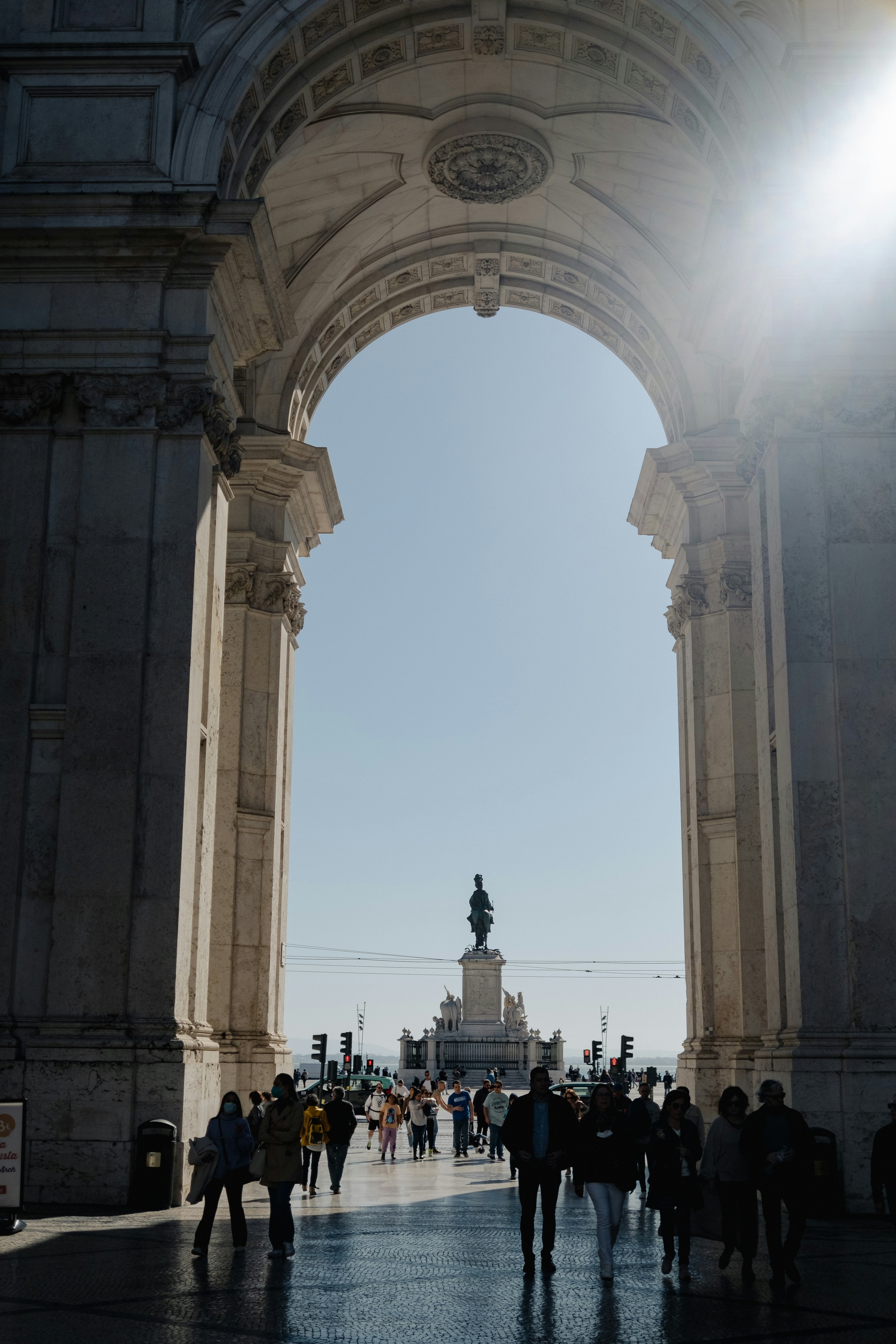a group of people walking under an archway
