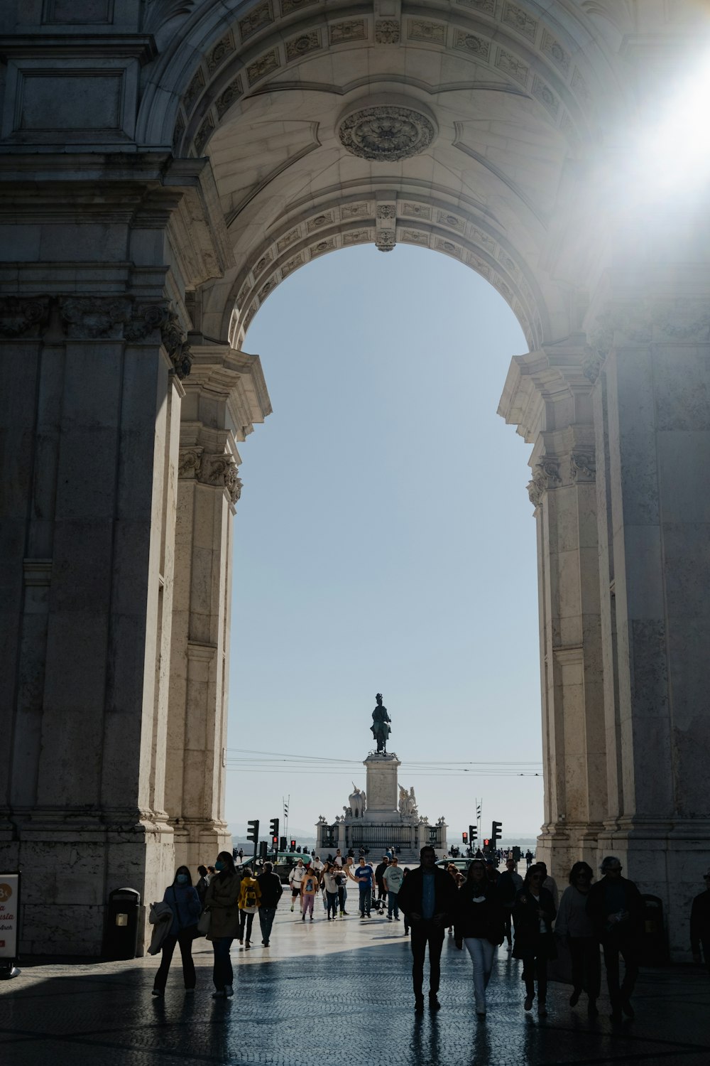 a group of people walking under an archway