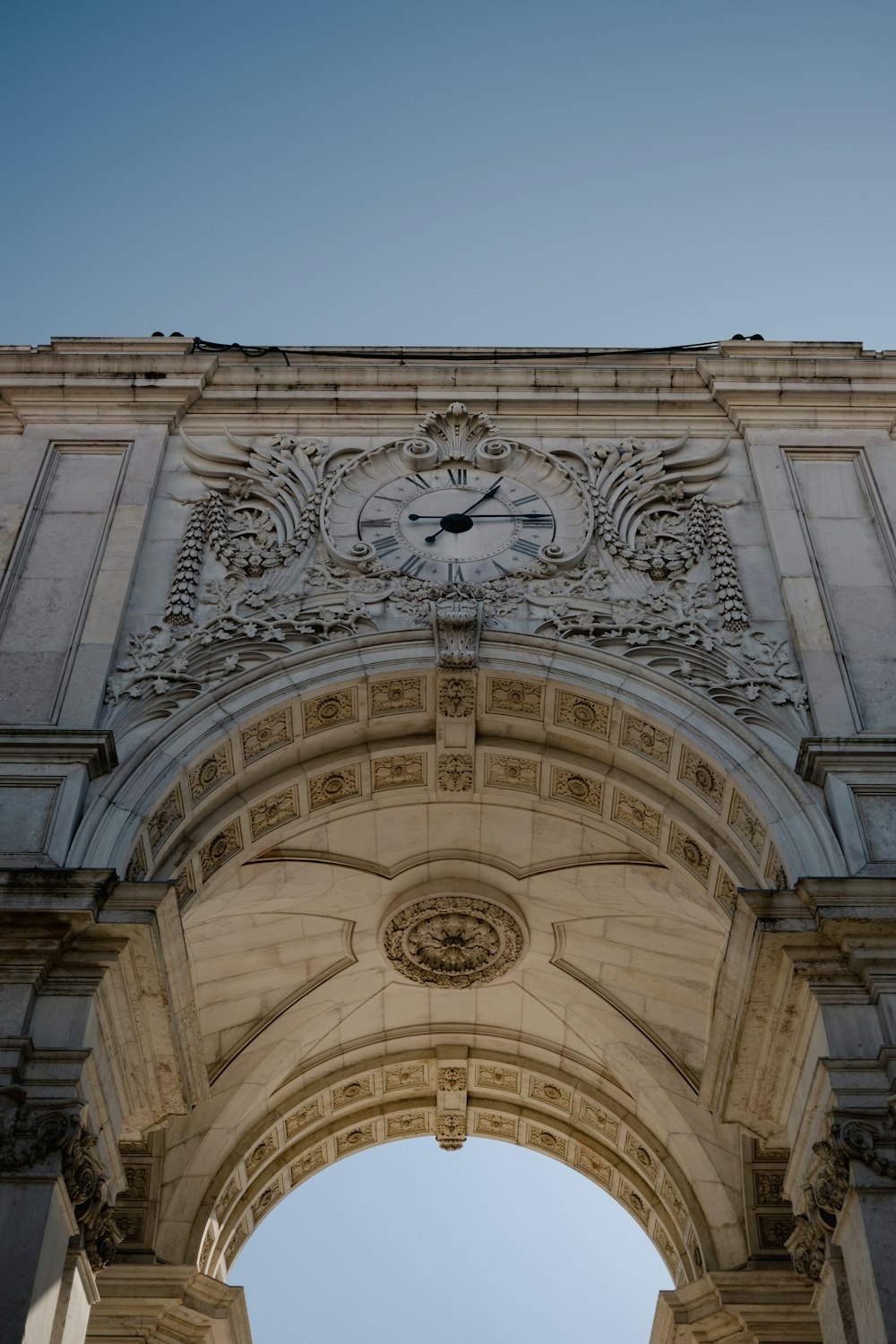 a large stone arch with a clock on it