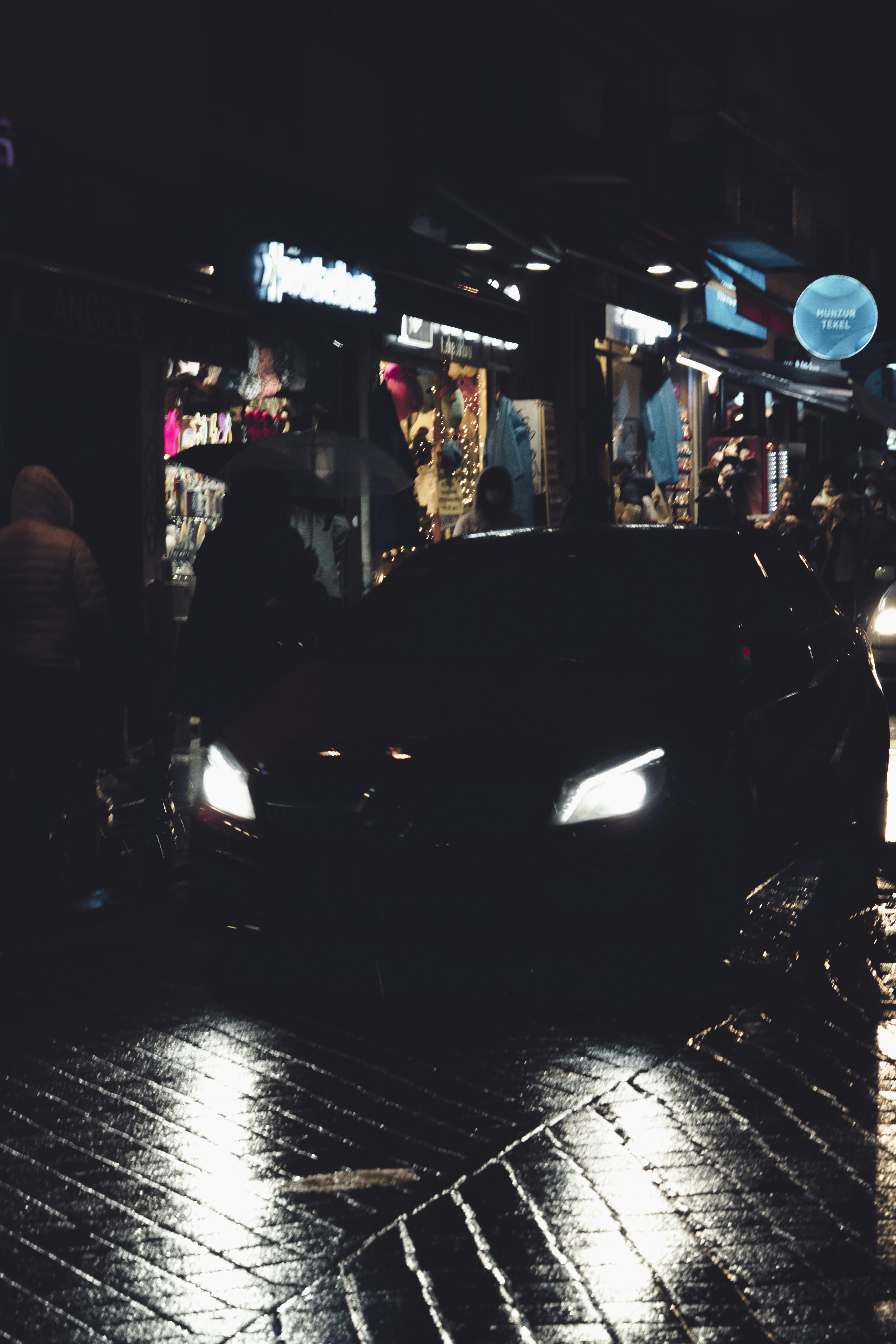 a car driving down a street at night