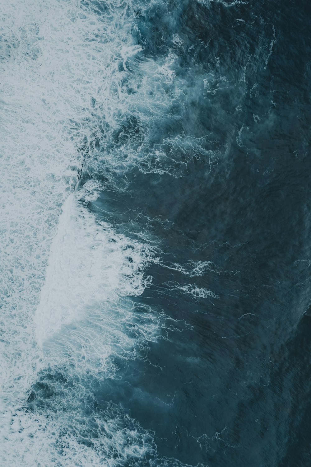 a man riding a wave on a surfboard in the water