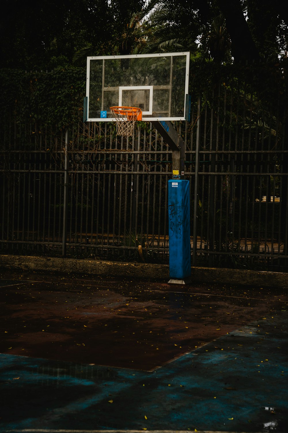 a basketball hoop in front of a fence