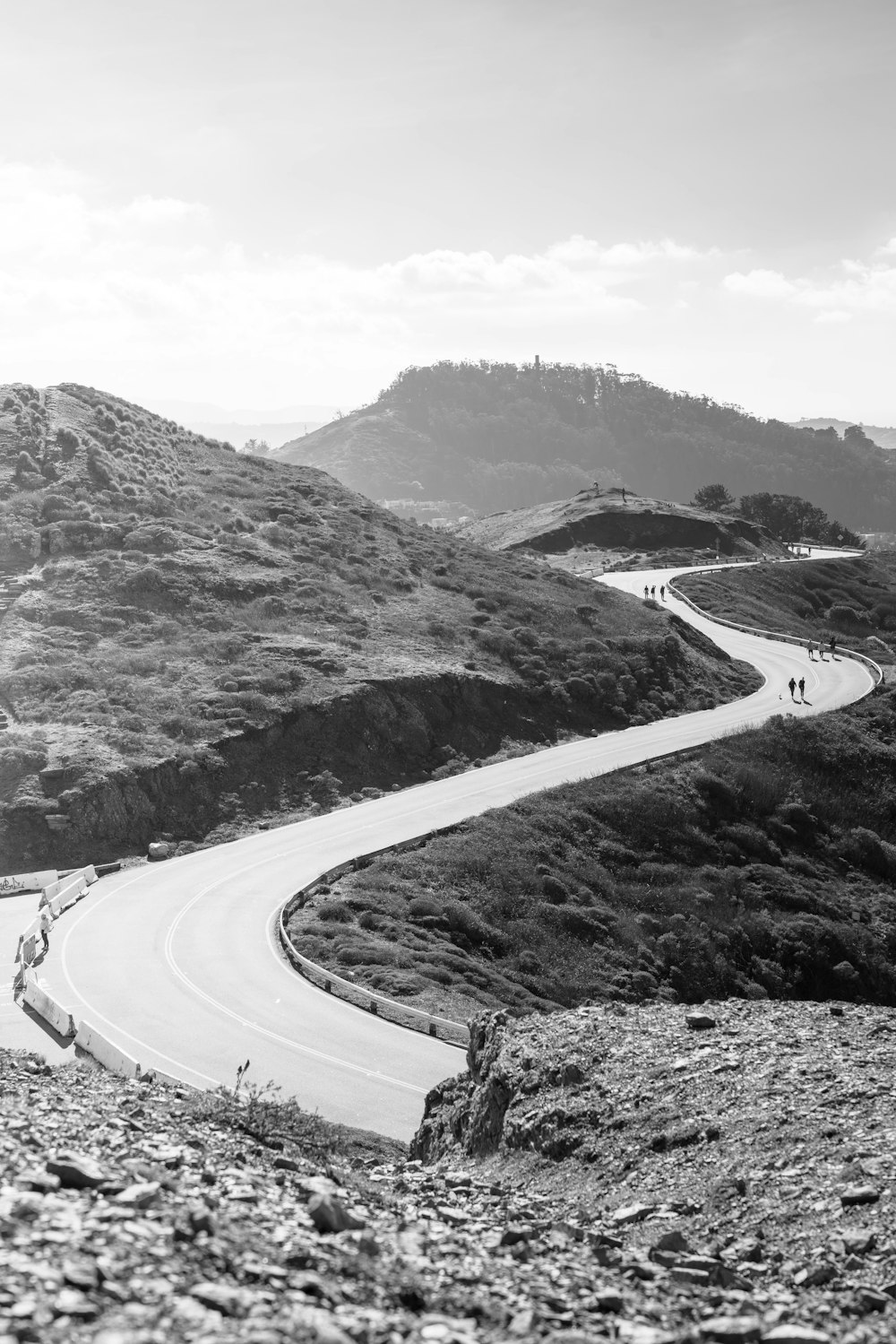 a black and white photo of a winding road