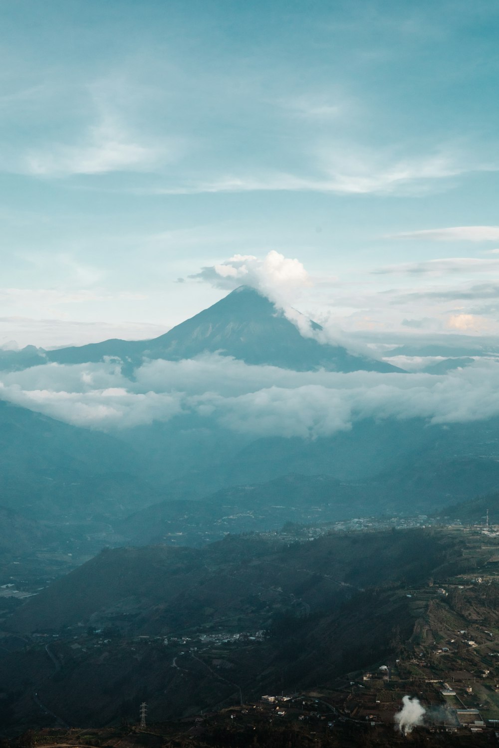 a view of a mountain with clouds in the sky