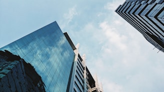 a couple of tall buildings sitting next to each other