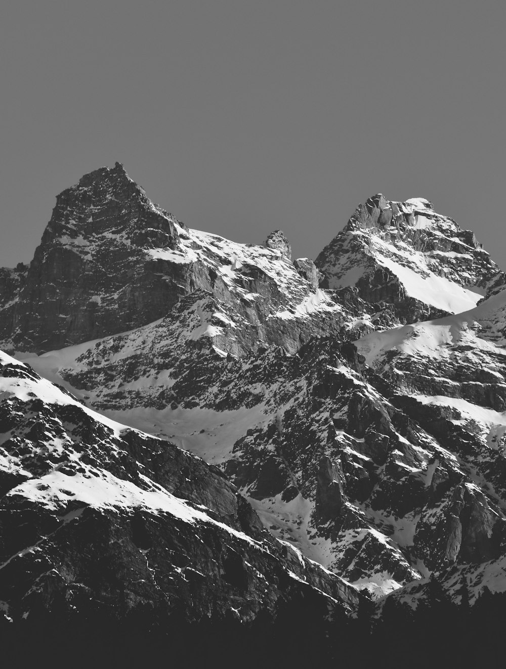 a black and white photo of a mountain range