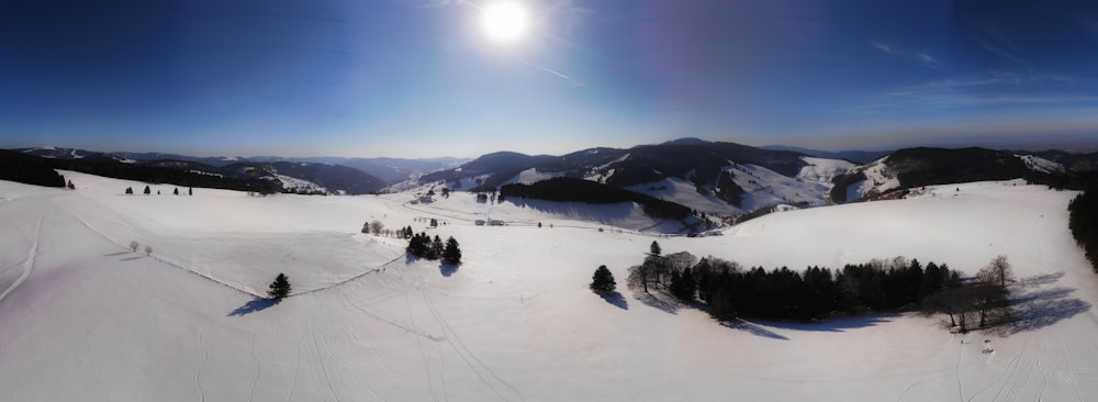 the sun is shining over a snowy mountain