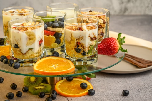 a plate of fruit, yogurt, and granola on a table