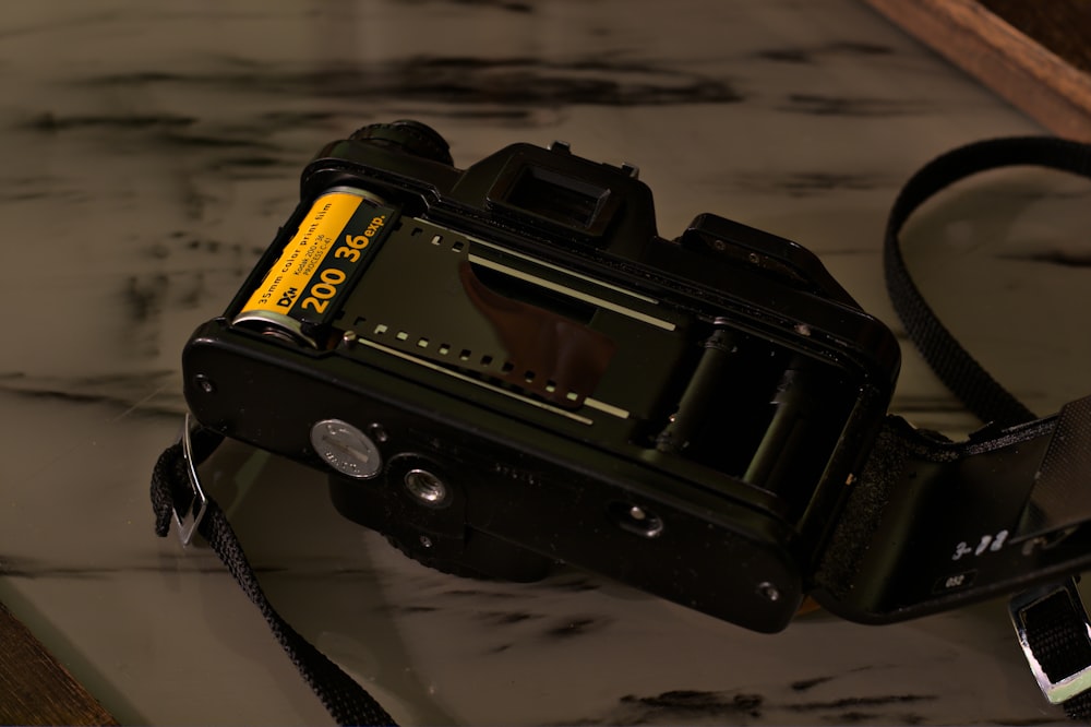 a camera sitting on top of a table next to a mirror