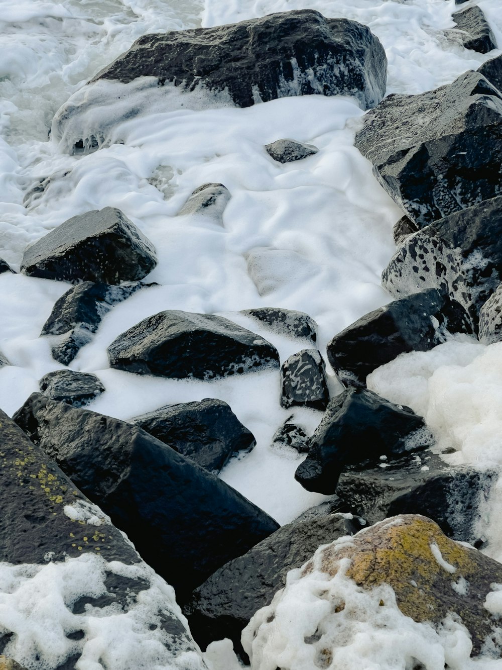 a bunch of rocks that are covered in snow