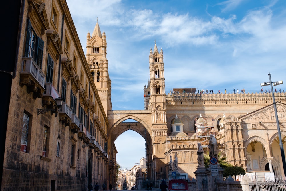 a city street lined with tall buildings under a blue sky