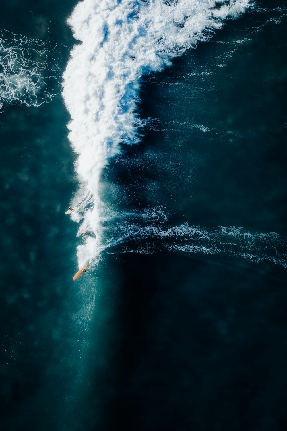 a person riding a surfboard on a wave in the ocean