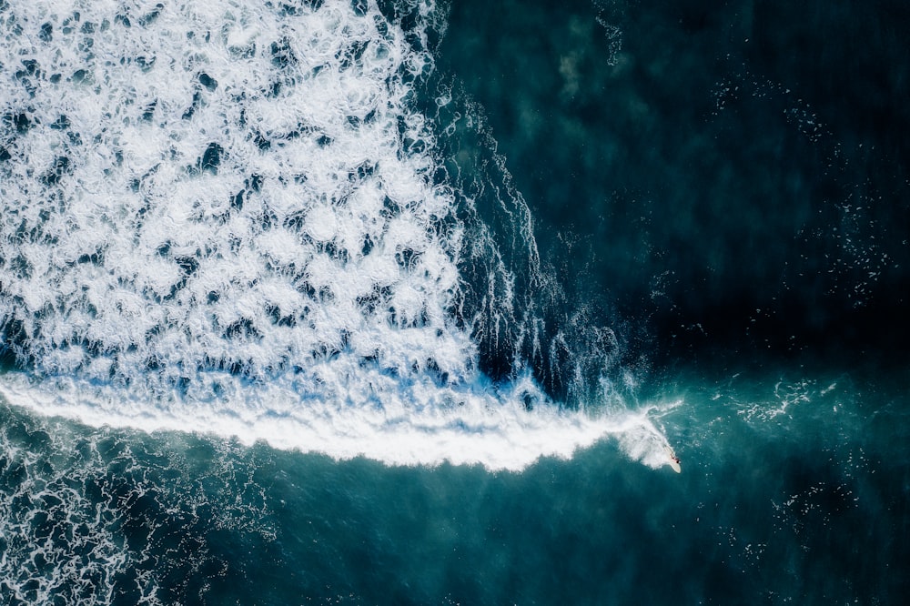 an aerial view of a wave in the ocean