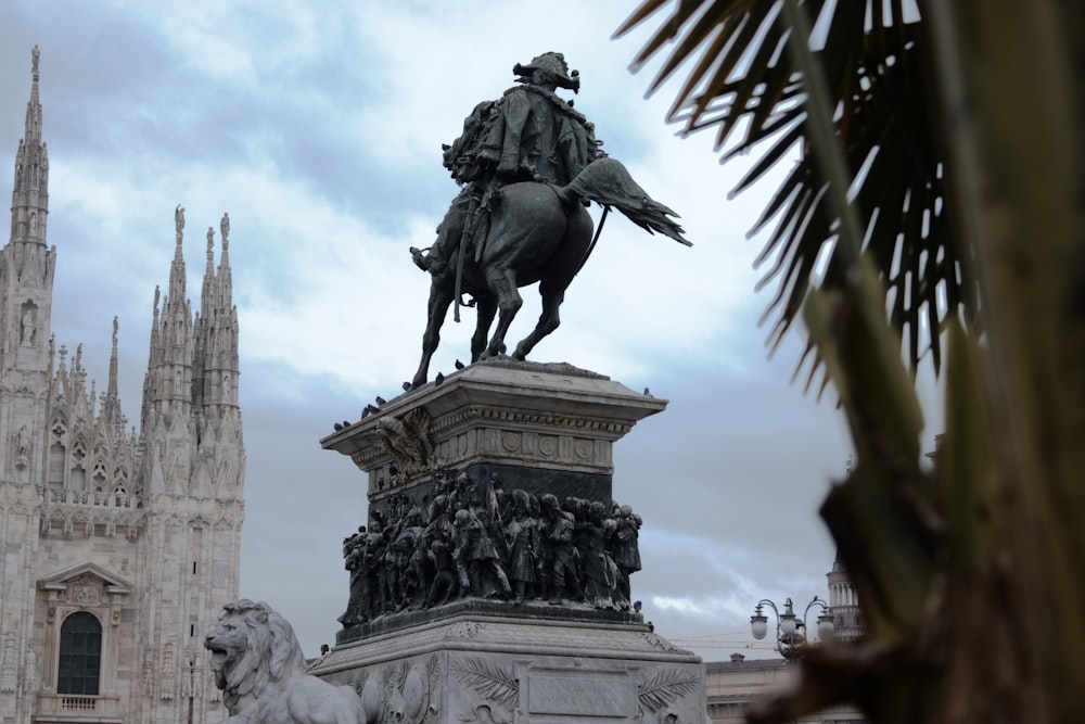 a statue of a man on a horse in front of a cathedral